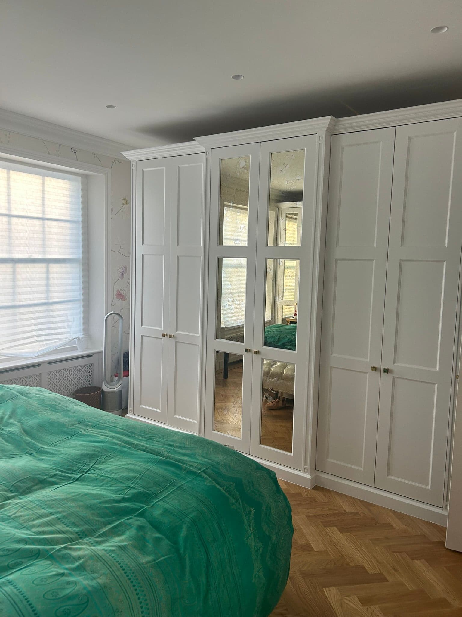 Bedroom with fitted joinery and parquet flooring