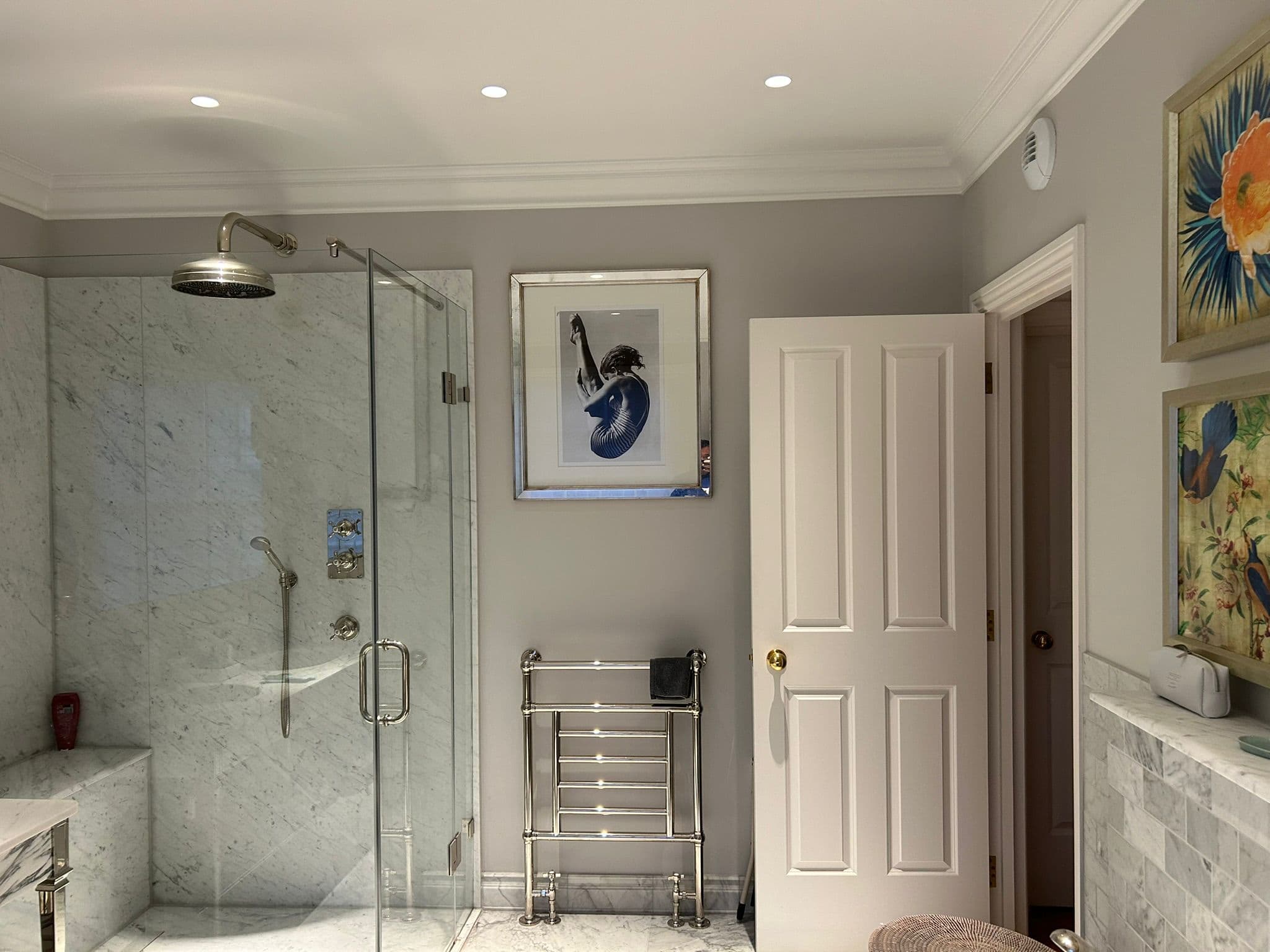 Marble shower room with chrome fittings in a central London residence