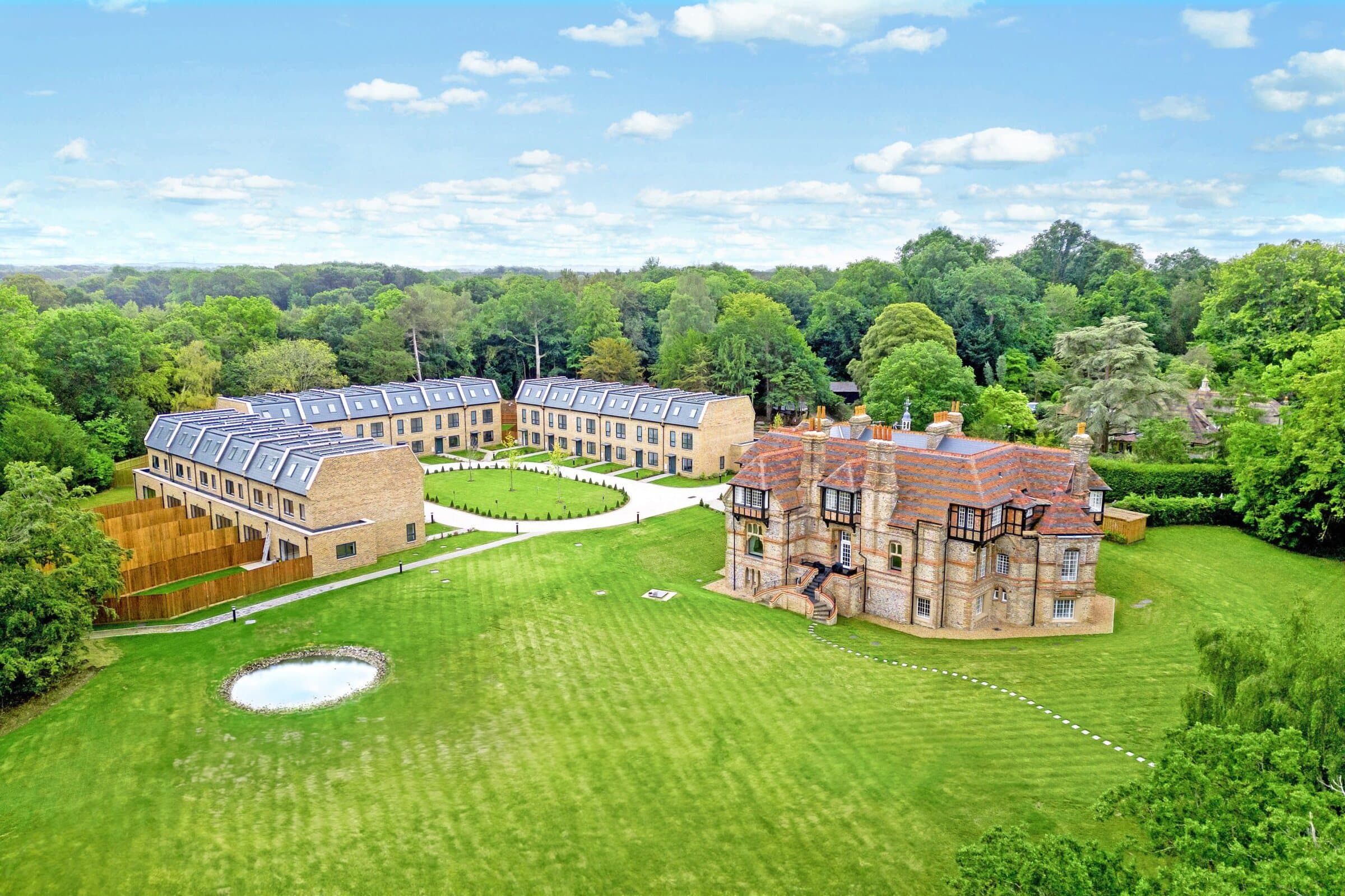 Aerial view of a completed private heritage estate in Kent, restored manor and new courtyard homes
